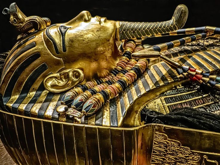 Egypt Tours Second inner coffin with lid removed exposing King Tutankhamuns mummy wearing the gold death mask New Kingdom 18th Dynasty Egypt 1332 1323 BCE